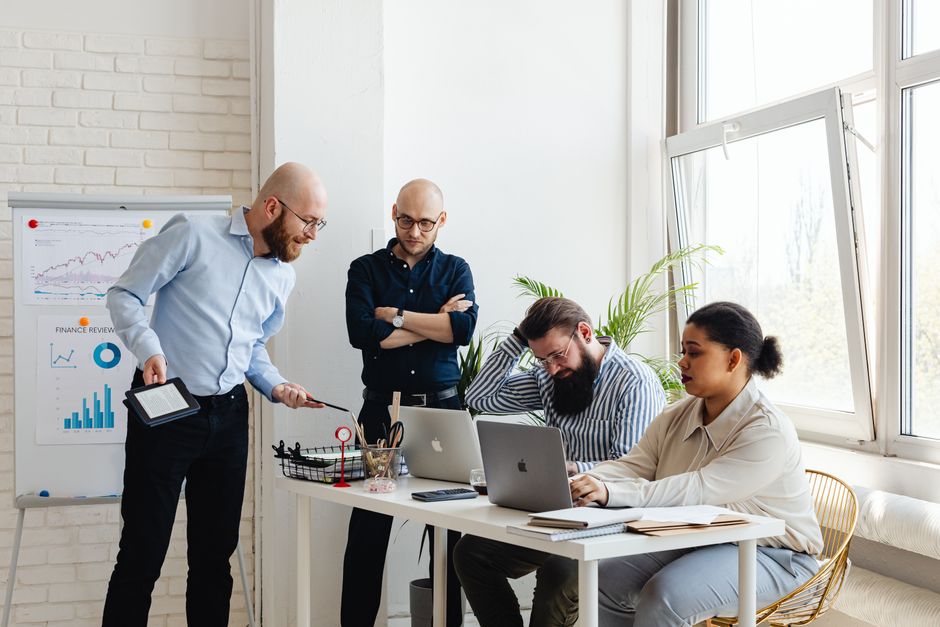 Colleagues in a meeting discussing work and feedback in an office