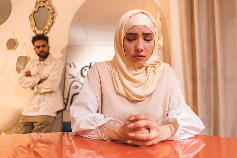 Couple sitting apart after an argument, reflecting quietly